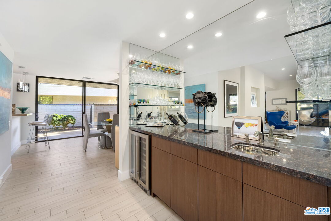78 Colgate Drive Rancho Mirage, CA 92270 - Photo 7 of 56 a kitchen with stainless steel appliances granite countertop sink stove and wooden cabinets