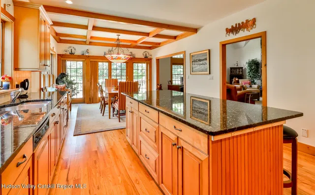 a living room with furniture a fireplace and a floor to ceiling window