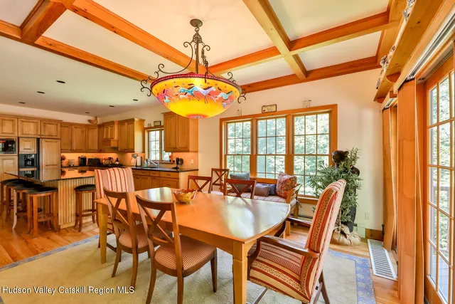 a living room with furniture a flat screen tv and a floor to ceiling window