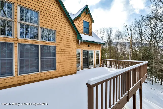 a bedroom with a bed and a flat tv screen on dresser
