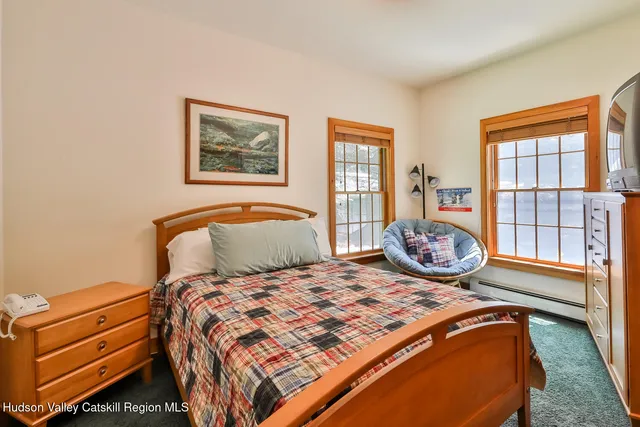 a very nice looking bedroom with a large window and a bed