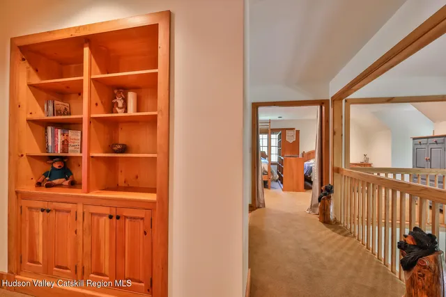 a view of a house with wooden fence and potted plants