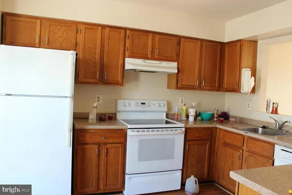 a kitchen with a sink a stove and cabinets