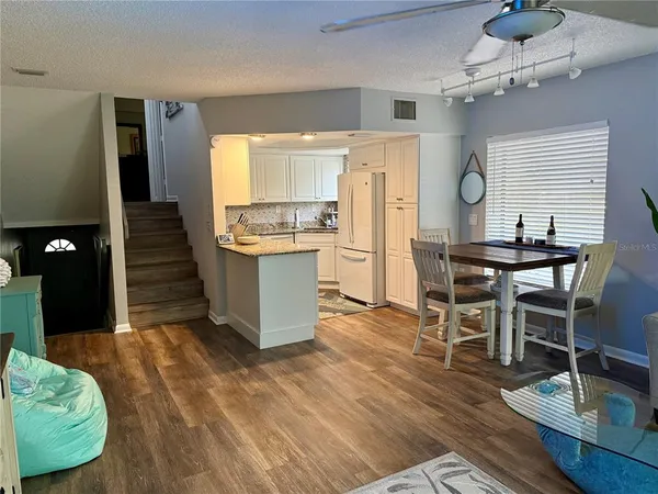 a view of a dining room with furniture and wooden floor