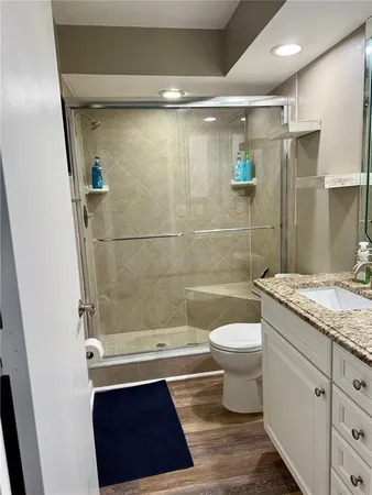 a bathroom with a sink a toilet and shower