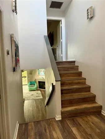 a view of entryway and hall with wooden floor