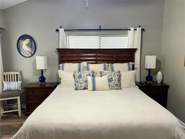 a bedroom with a bed and a painting on the wall