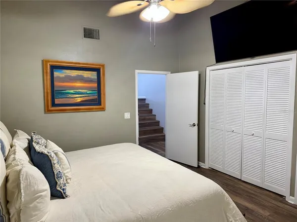 a bedroom with a bed and a chandelier
