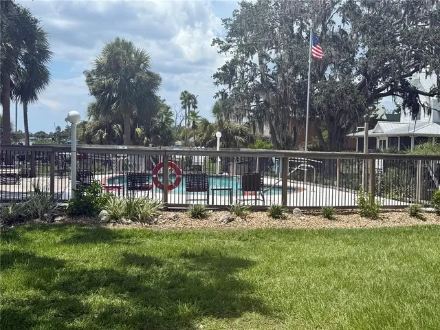 a view of a house with backyard and sitting area