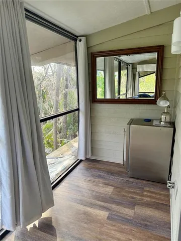 a living room with furniture and a floor to ceiling window