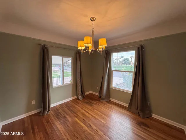 an empty room with closet and a chandelier fan