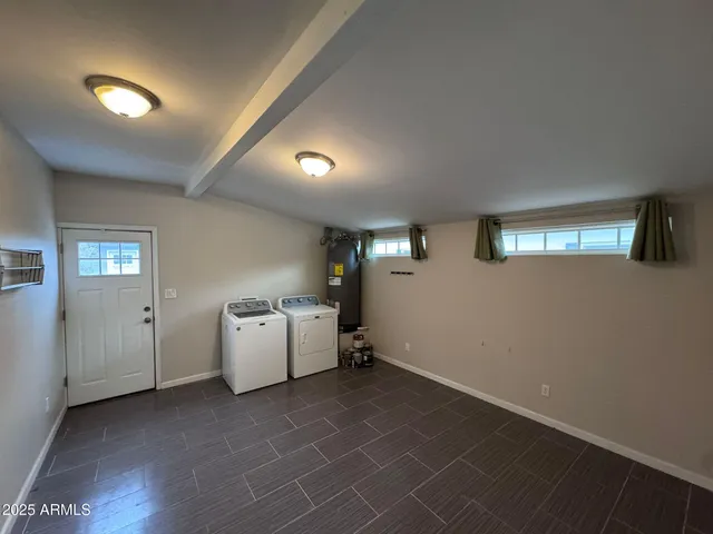 an empty room with windows and ceiling fan