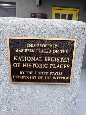 a front view of a house with large trees