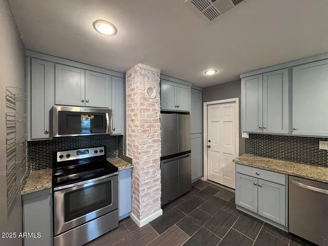 a kitchen with refrigerator and stove