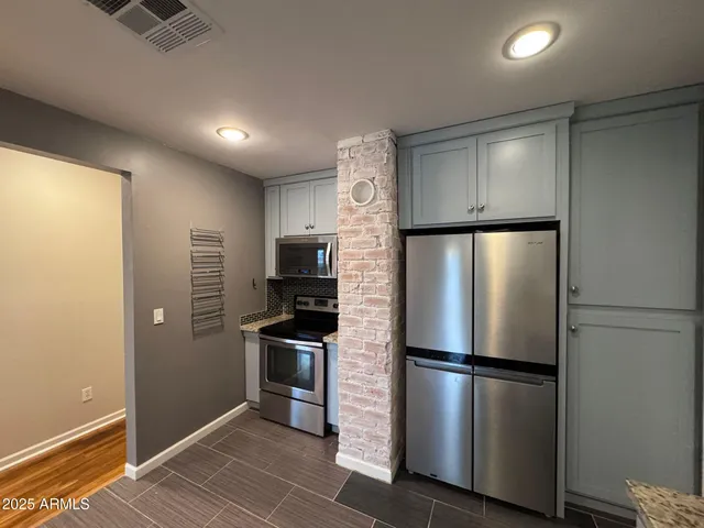 a kitchen with granite countertop a sink and cabinets