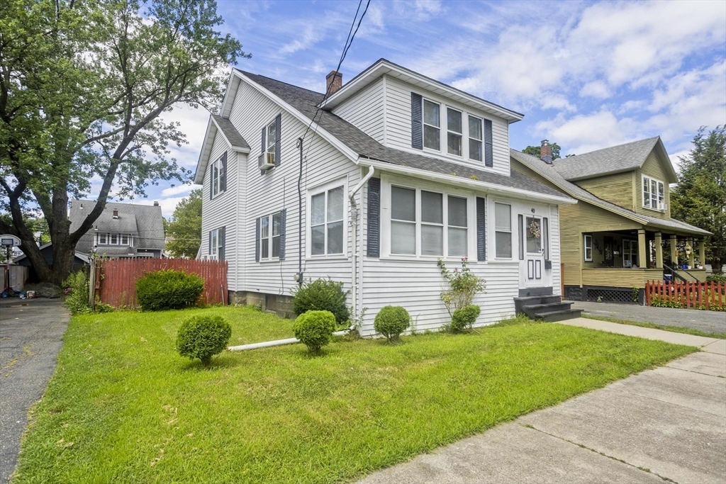 a front view of a house with a yard and porch