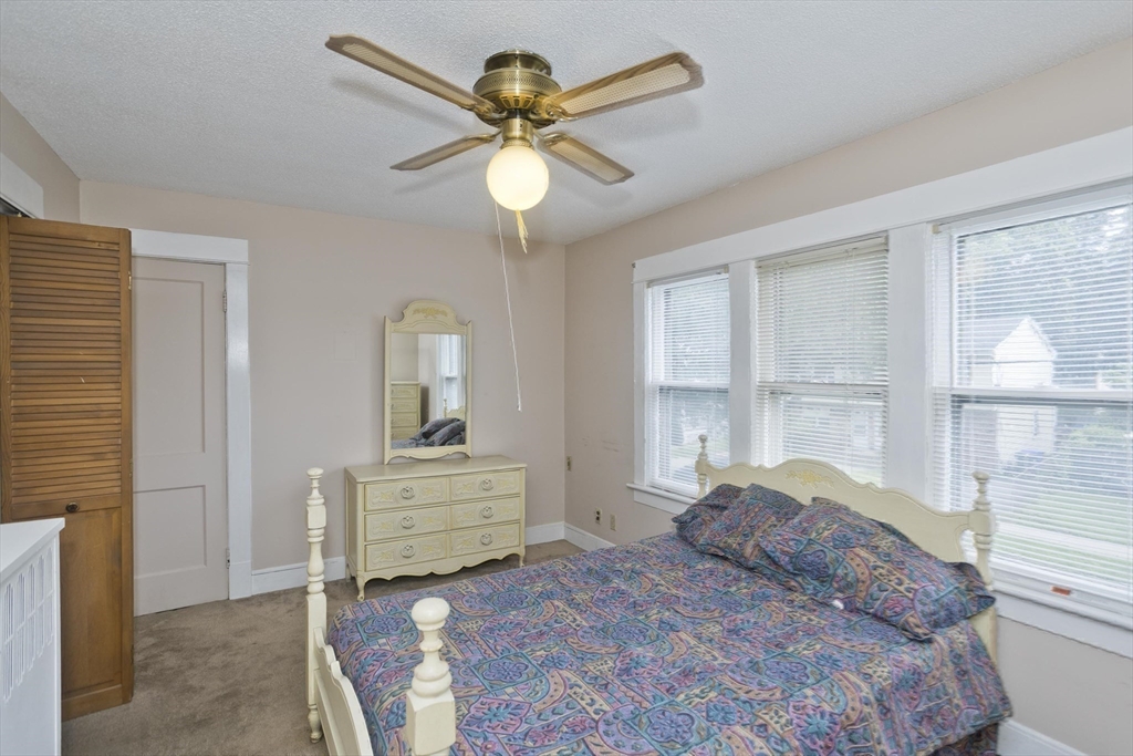 40 Eldridge Street Springfield, MA 01108 - Photo 12 of 22 a bedroom with a bed and a chandelier