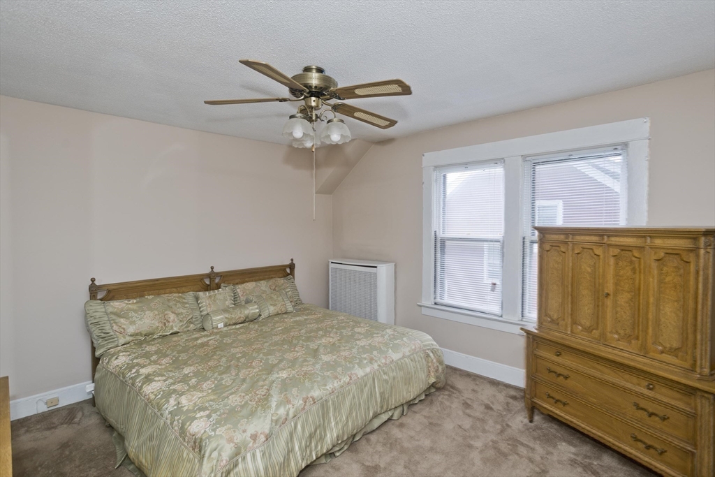 40 Eldridge Street Springfield, MA 01108 - Photo 17 of 22 a bedroom with a bed and cabinets