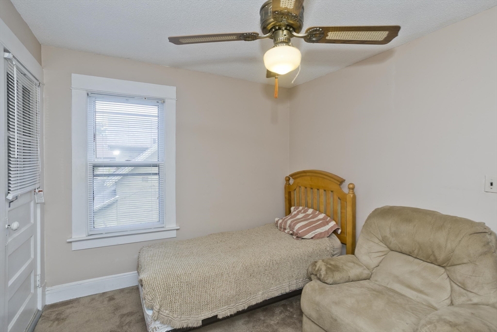 40 Eldridge Street Springfield, MA 01108 - Photo 18 of 22 a bedroom with a bed and window