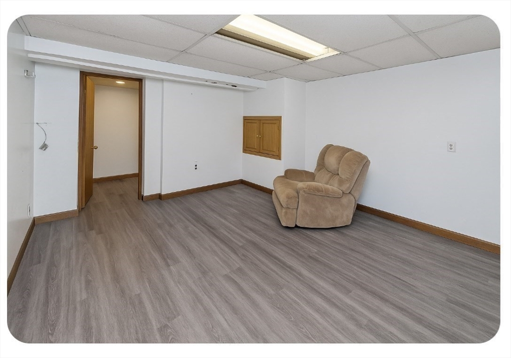 40 Eldridge Street Springfield, MA 01108 - Photo 21 of 22 a living room with a wooden floor and a couch