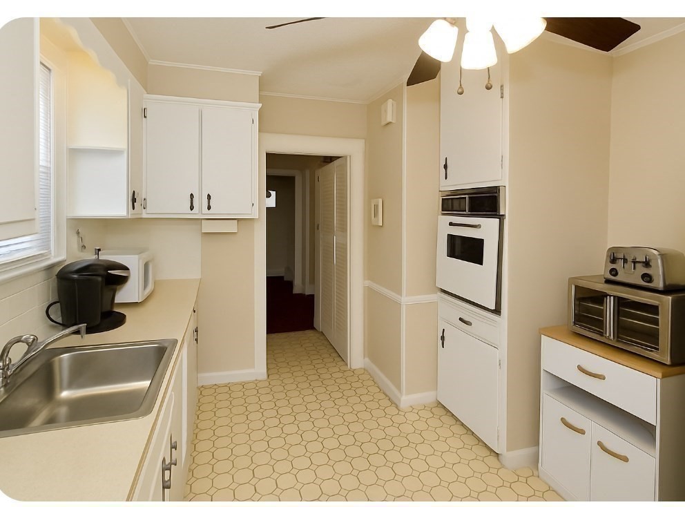 40 Eldridge Street Springfield, MA 01108 - Photo 6 of 22 a kitchen with a sink and a refrigerator