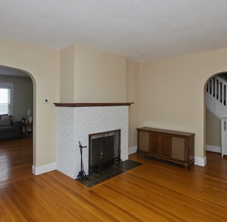 40 Eldridge Street Springfield, MA 01108 - Photo 8 of 22 a view of a livingroom with wooden floor and a fireplace
