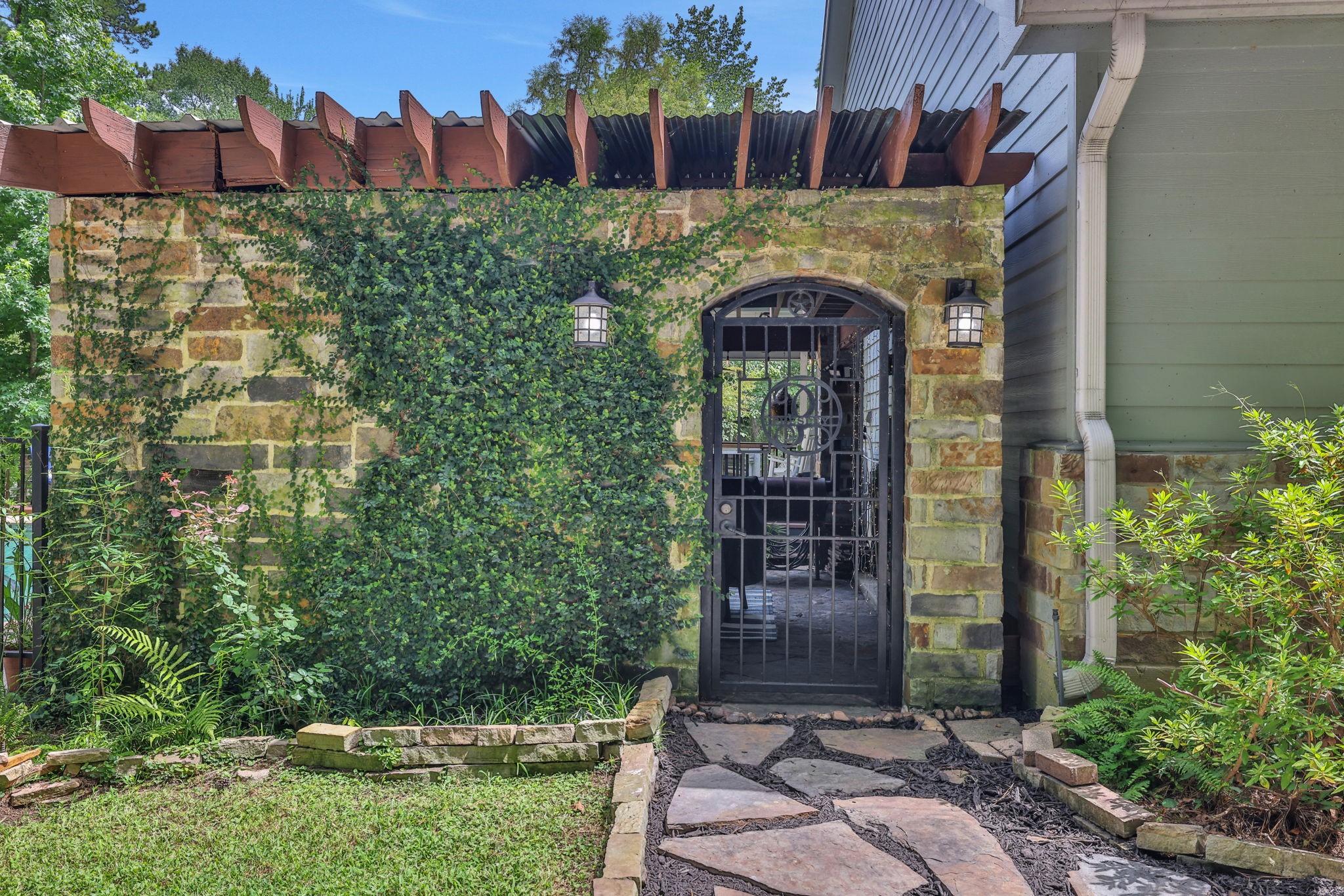 991 Kings Way Coldspring, TX 77331 - Photo 40 of 49 This side entrance from the driveway takes you to the outdoor kitchen area