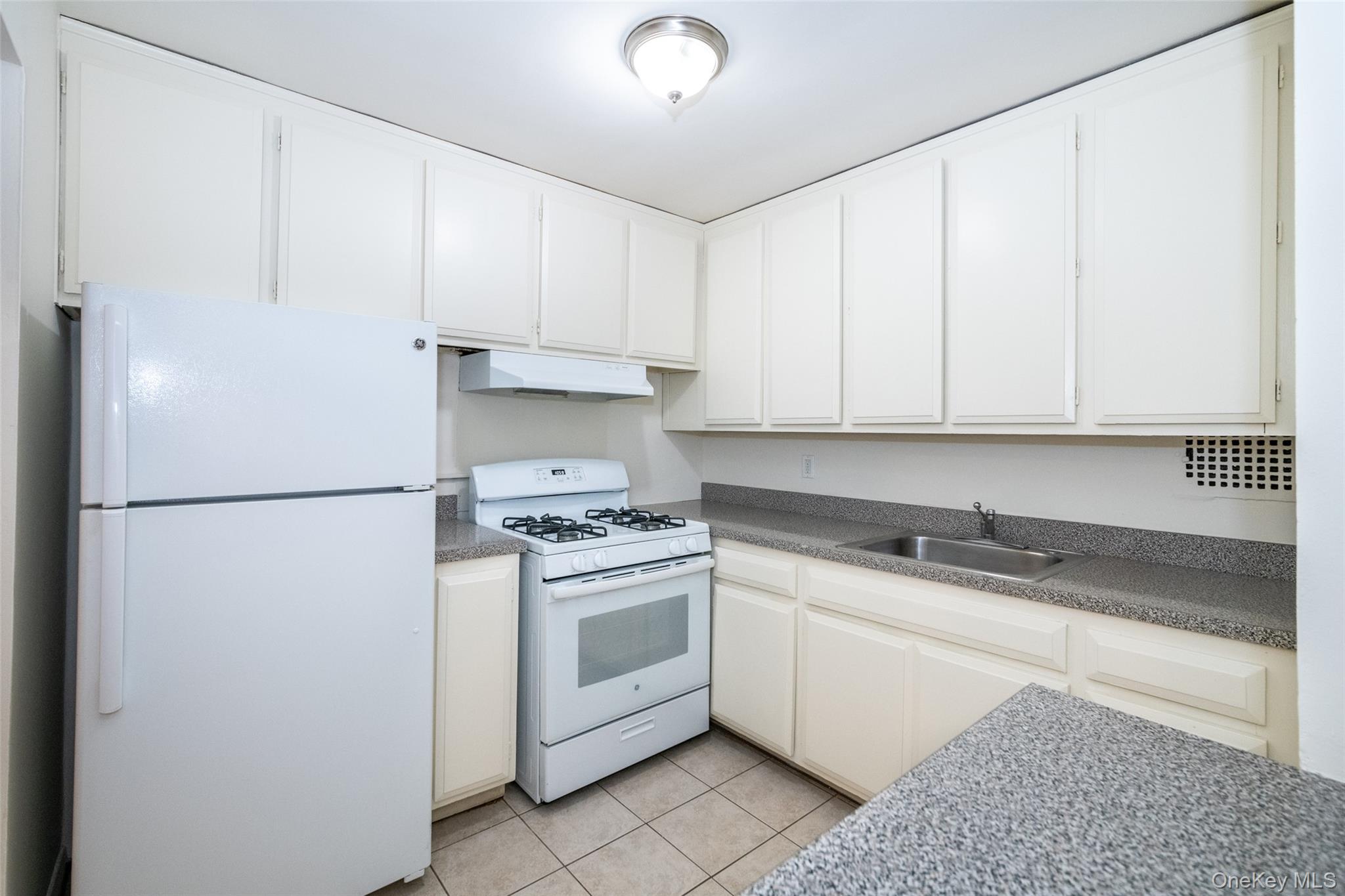 15 Lake Street, Unit 2D White Plains, NY 10603 - Photo 4 of 10 a kitchen with appliances a sink and cabinets