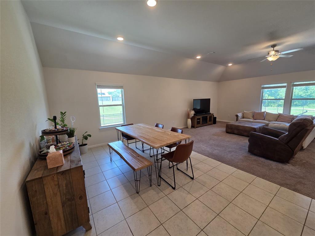 1512 Springtree Drive McKinney, TX 75071 - Photo 8 of 23 a living room with furniture a flat screen tv and a window