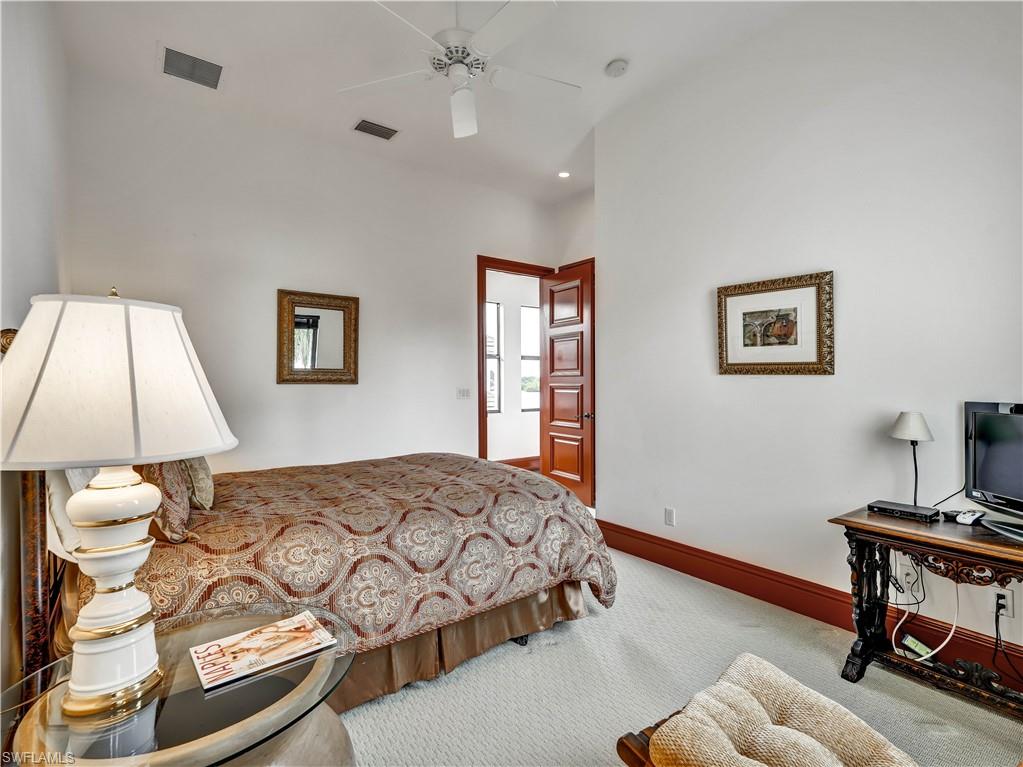 2535 Tarpon Road Naples, FL 34102 - Photo 30 of 50 Curved window with multiple vertical panes, white walls, and a red baseboard