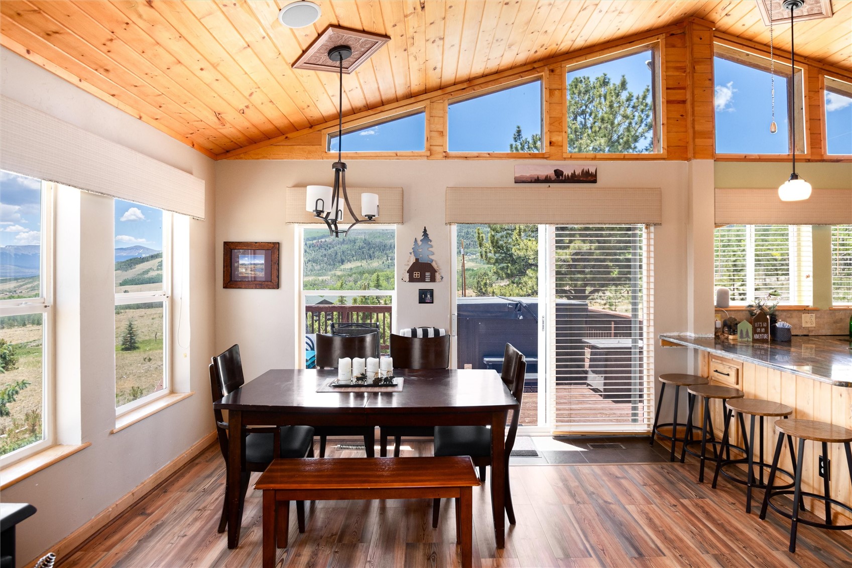 1301 Sheep Ridge Road Fairplay, CO 80440 - Photo 14 of 49 Vaulted wood-paneled ceiling with exposed beams, wood-finish flooring, and expansive windows showcasing mountain scenery
