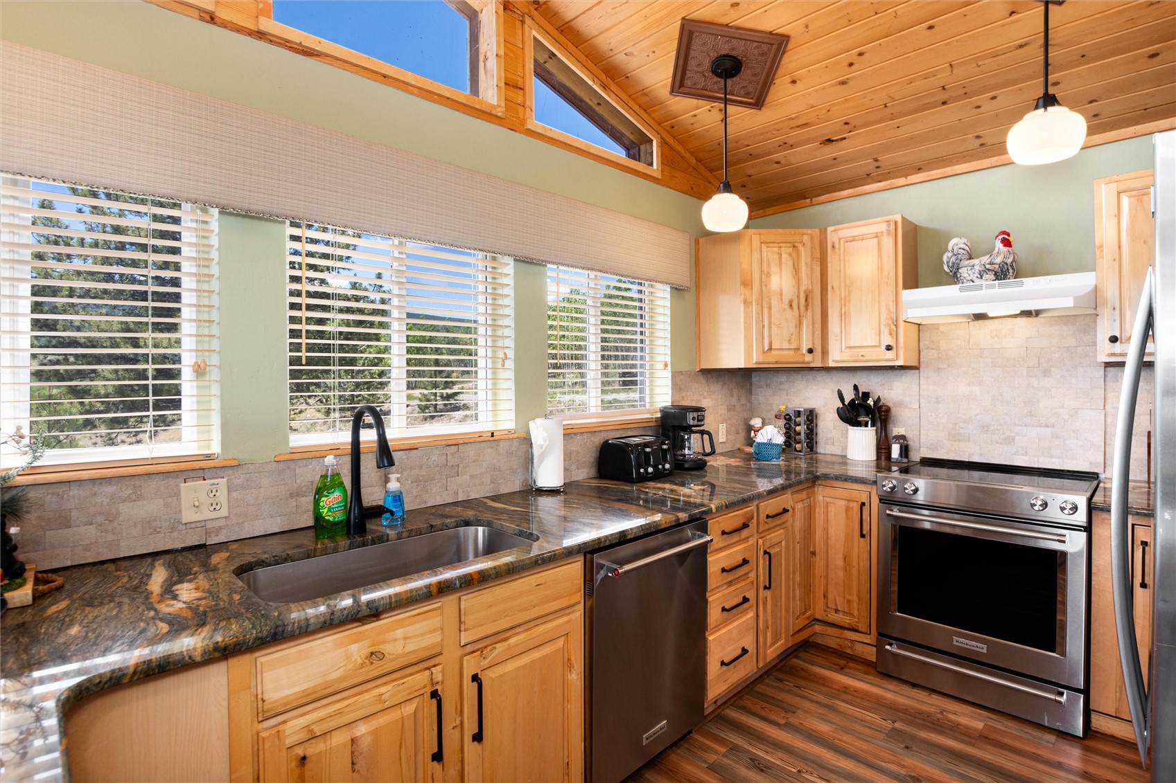 1301 Sheep Ridge Road Fairplay, CO 80440 - Photo 20 of 49 Kitchen featuring wood-finish flooring, natural wood cabinetry, and stone-look countertops