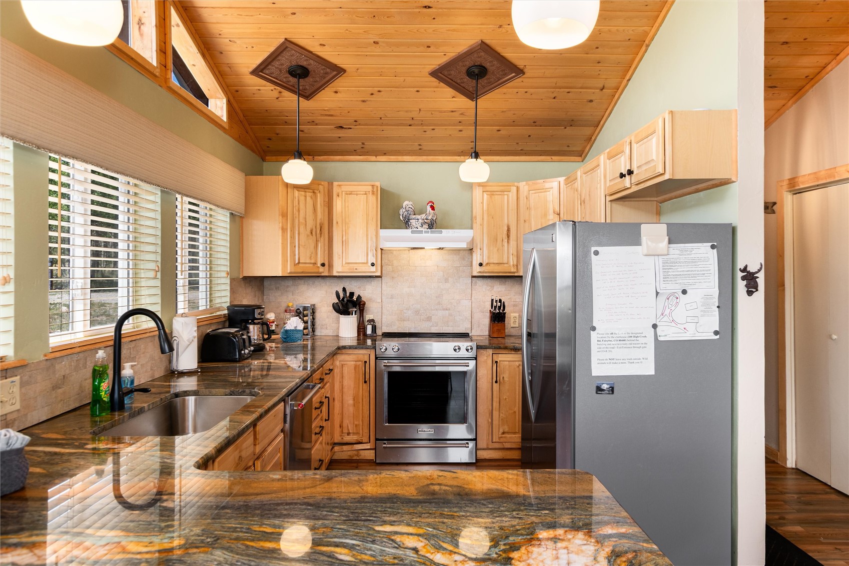 1301 Sheep Ridge Road Fairplay, CO 80440 - Photo 21 of 49 a kitchen with stainless steel appliances granite countertop a refrigerator a stove and a sink with granite countertops