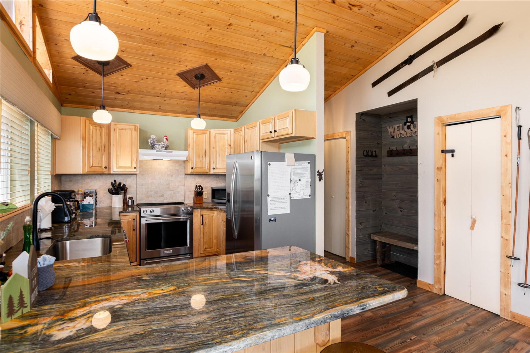 1301 Sheep Ridge Road Fairplay, CO 80440 - Photo 22 of 49 Kitchen featuring a wood-finish vaulted ceiling, natural wood cabinetry, stainless steel appliances, and a unique multi-toned stone countertop