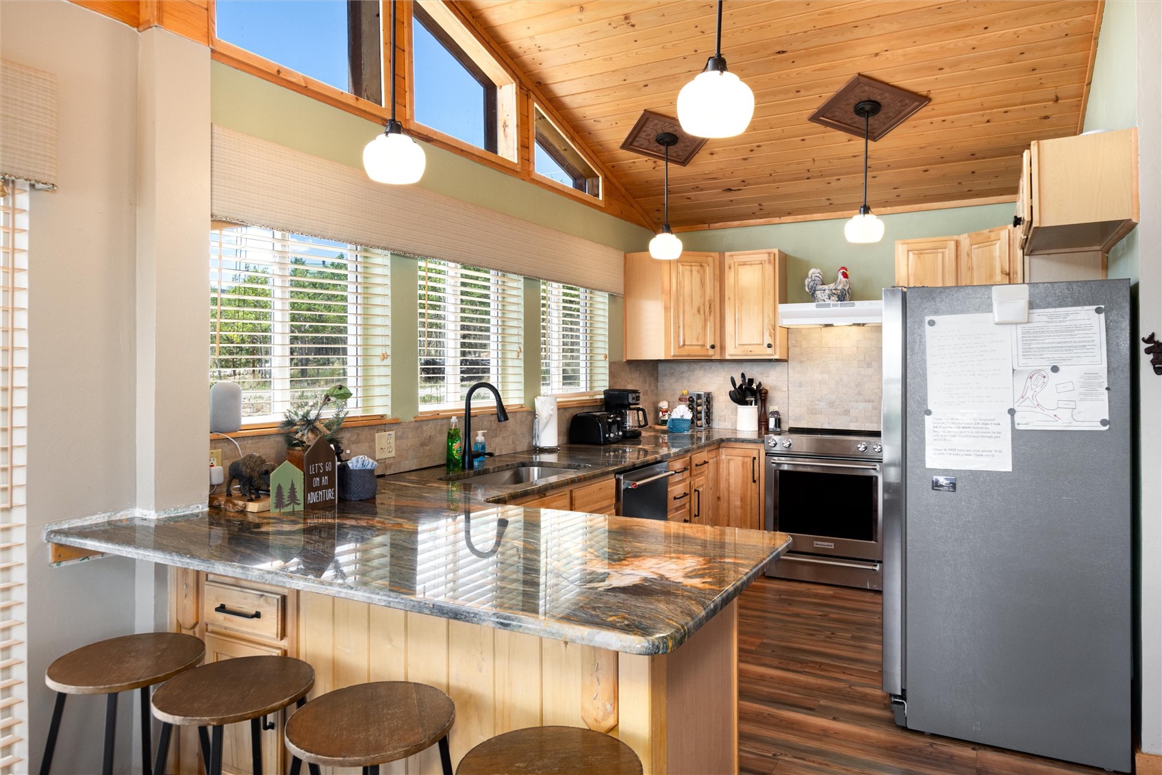 1301 Sheep Ridge Road Fairplay, CO 80440 - Photo 23 of 49 Kitchen featuring wood-finish flooring, natural wood cabinetry, and speckled granite countertops