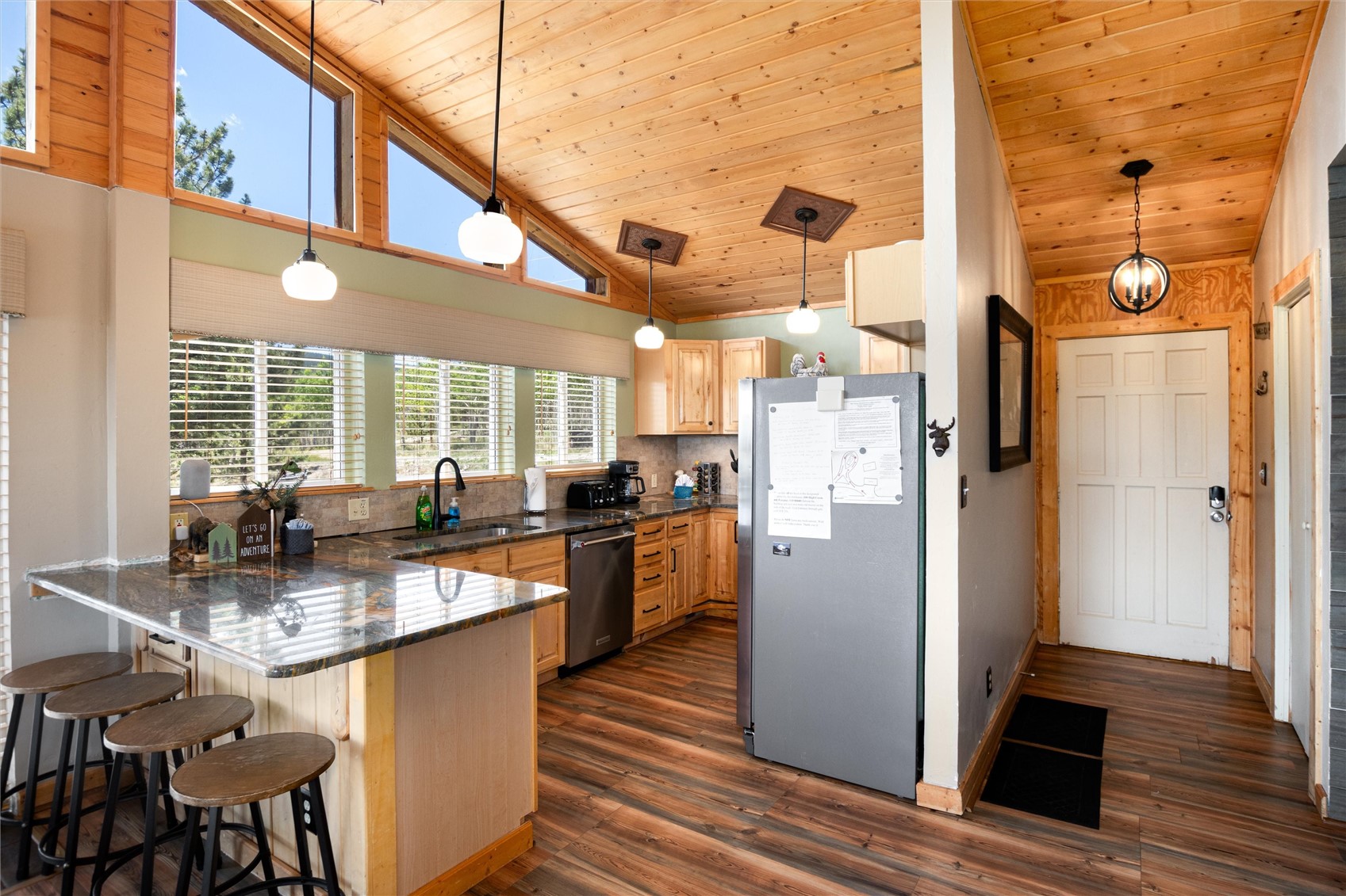 1301 Sheep Ridge Road Fairplay, CO 80440 - Photo 24 of 49 Kitchen and entryway featuring wood-finish flooring and a vaulted wood-paneled ceiling