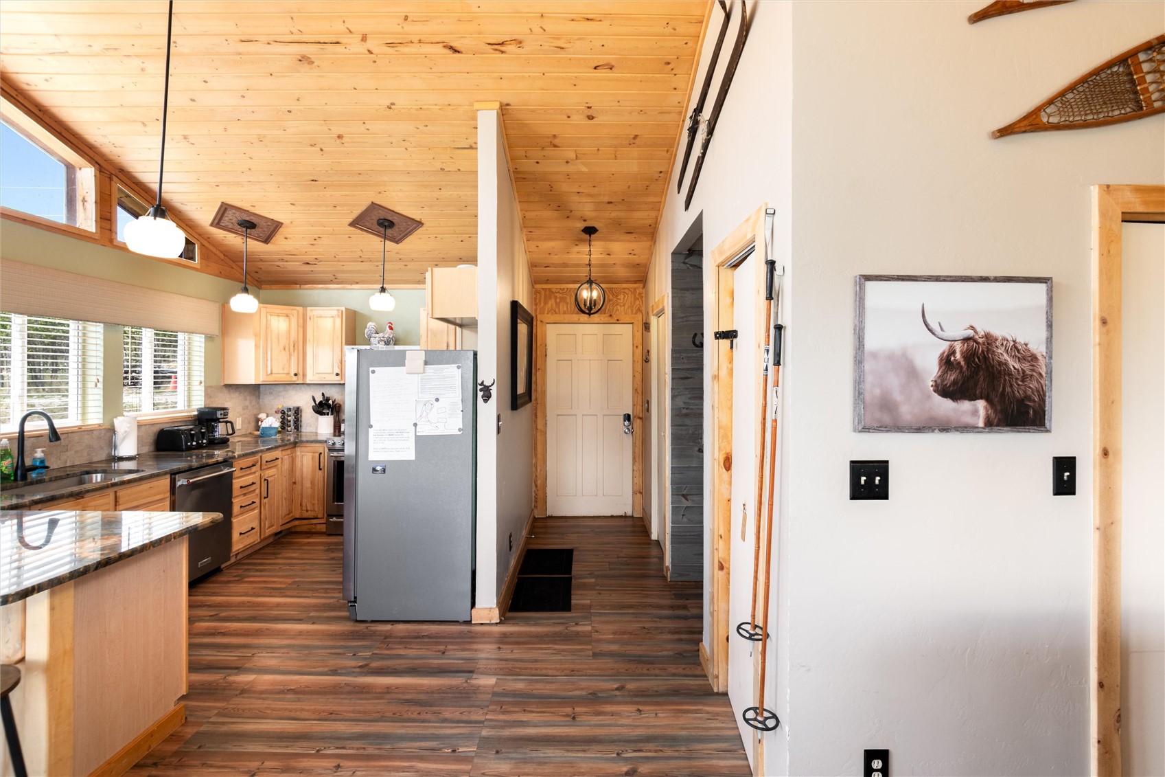 1301 Sheep Ridge Road Fairplay, CO 80440 - Photo 25 of 49 Open-concept kitchen featuring light wood cabinetry, stone countertops, wood-finish flooring, and a stainless steel refrigerator