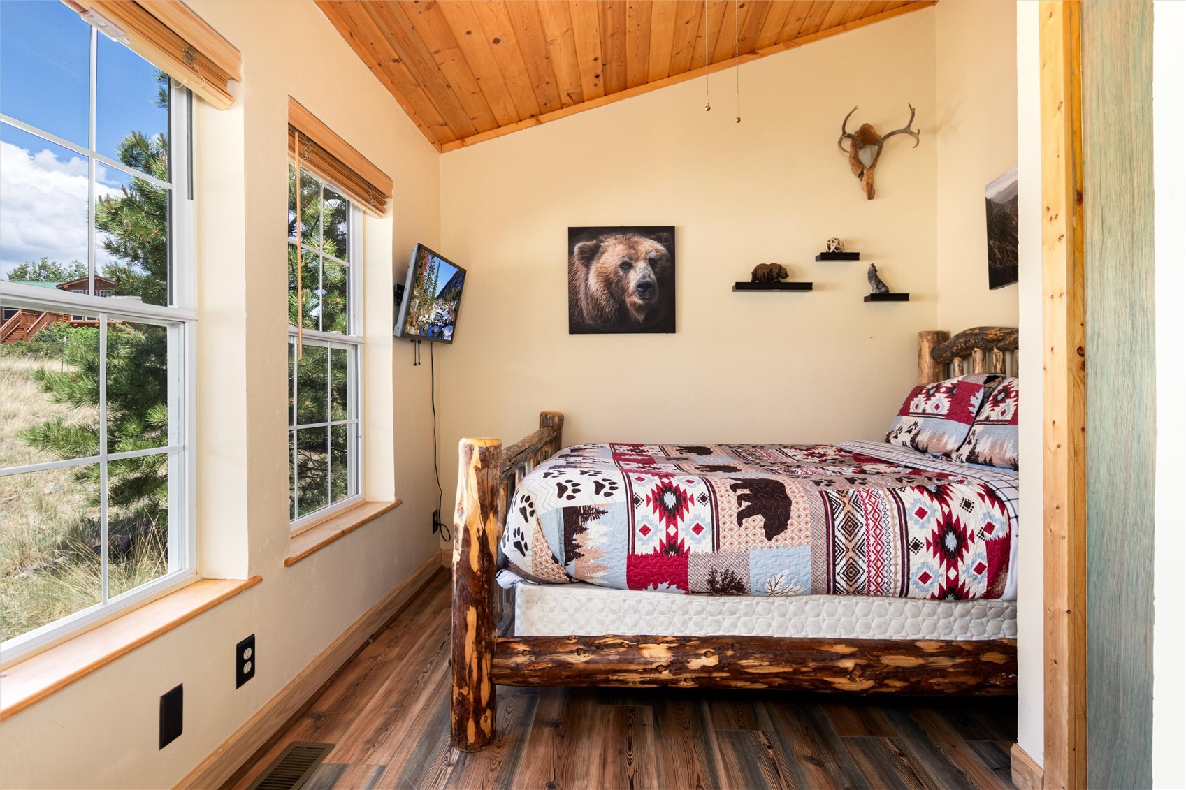 1301 Sheep Ridge Road Fairplay, CO 80440 - Photo 27 of 49 Room featuring multiple windows, wood-finish flooring, a wood plank vaulted ceiling, and built-in shelving