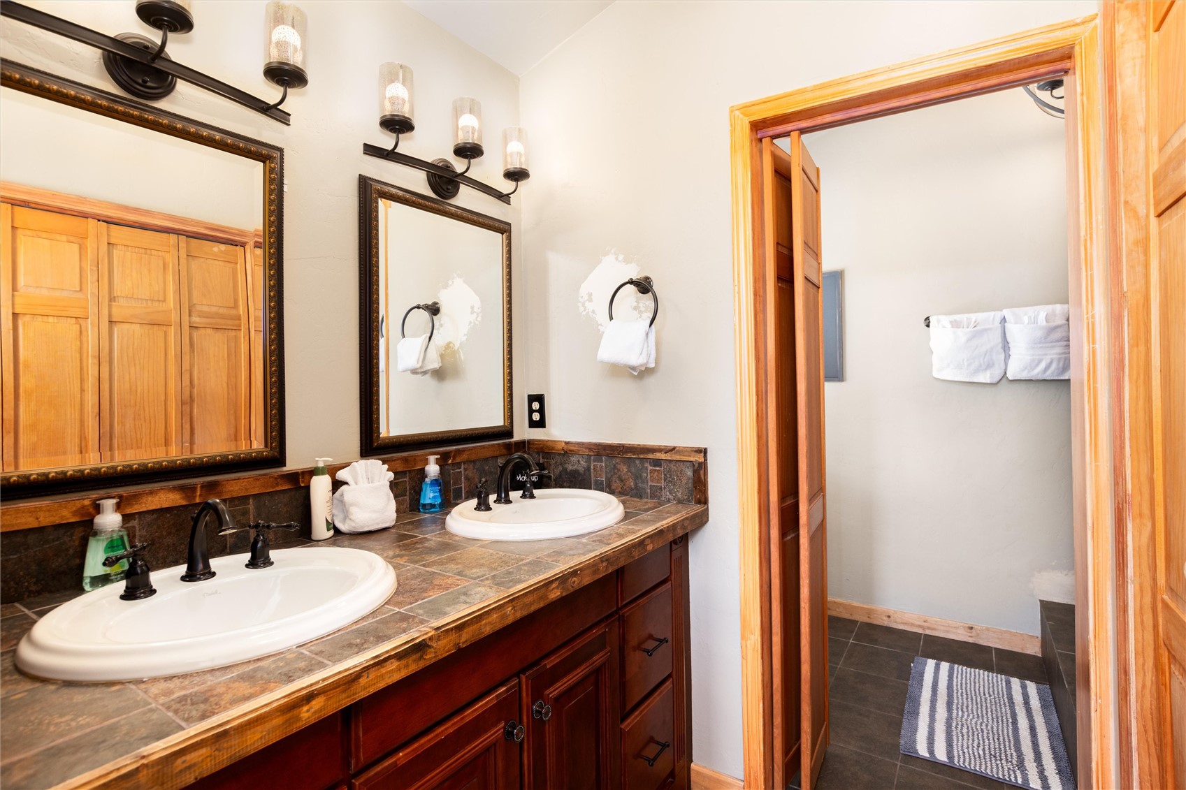 1301 Sheep Ridge Road Fairplay, CO 80440 - Photo 36 of 49 Dual vanity with undermount sinks and dark bronze fixtures set against a tile countertop