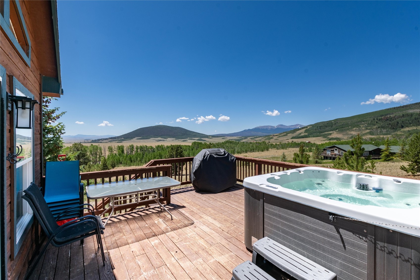 1301 Sheep Ridge Road Fairplay, CO 80440 - Photo 42 of 49 Spacious outdoor deck featuring a hot tub, wood flooring, and a railing system
