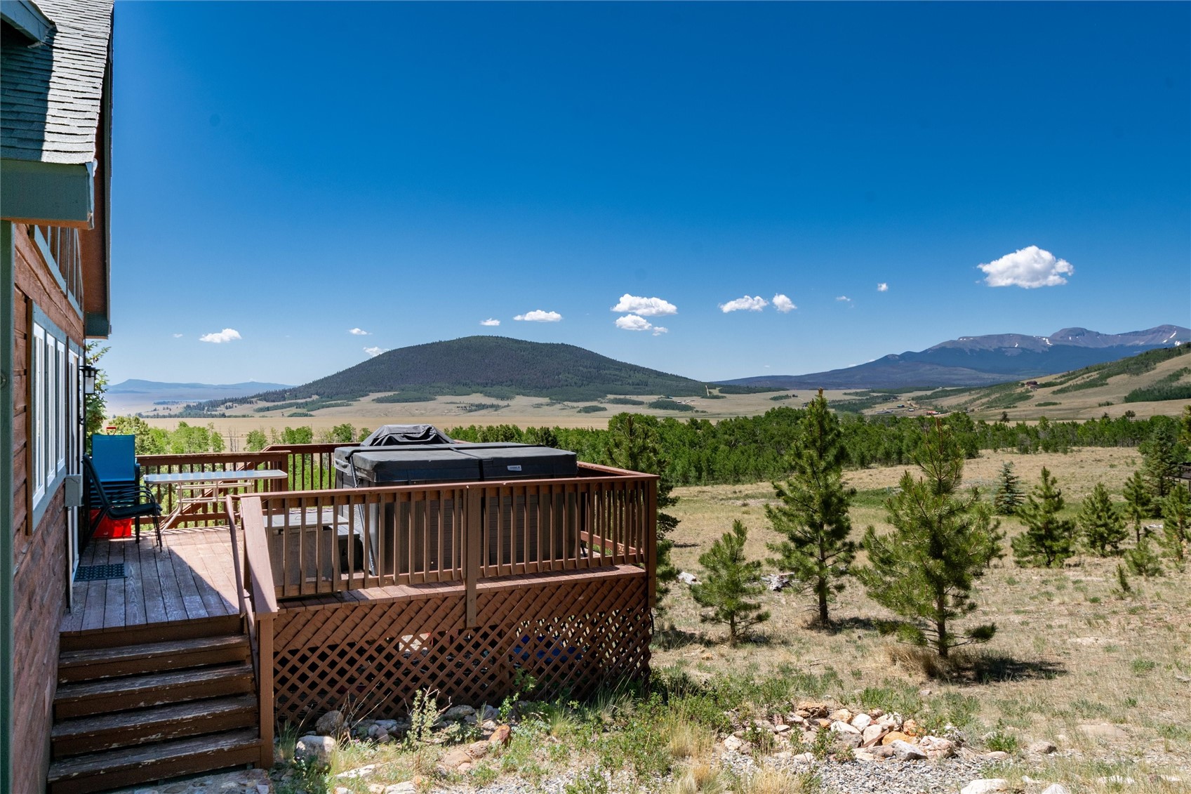 1301 Sheep Ridge Road Fairplay, CO 80440 - Photo 47 of 49 Expansive wooden deck featuring a hot tub, lattice skirting, and a railing system