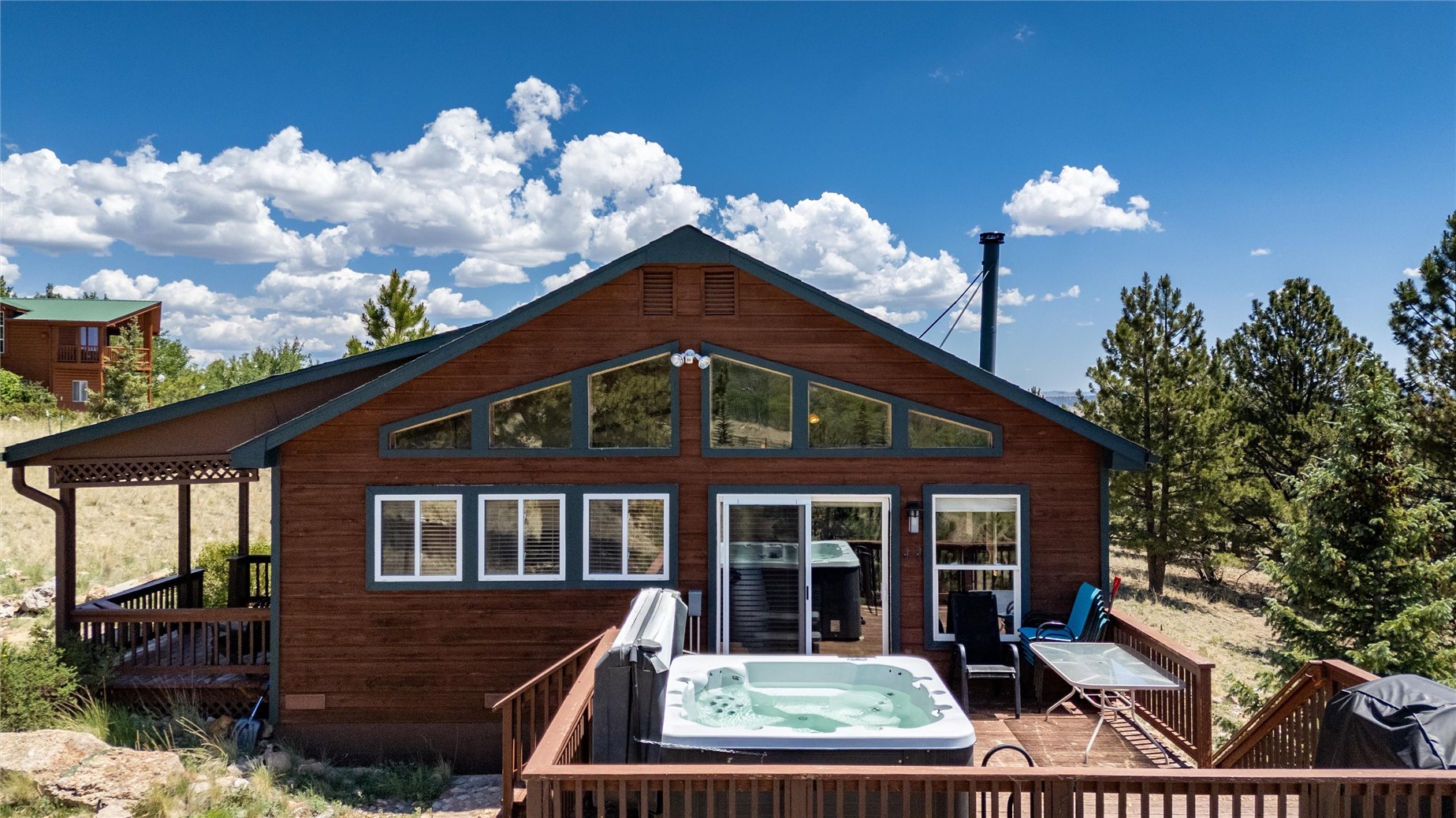 1301 Sheep Ridge Road Fairplay, CO 80440 - Photo 5 of 49 Wood-sided property featuring a spacious outdoor deck with an integrated hot tub