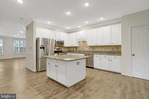 a view of a kitchen with granite countertop white cabinets and a granite counter tops