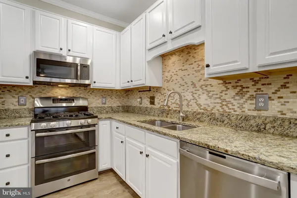 a kitchen with granite countertop cabinets and window
