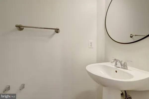 a bathroom with a granite countertop toilet sink and mirror