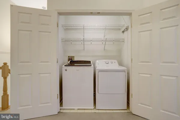 an empty room with a chandelier fan