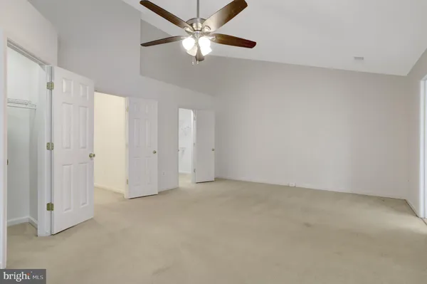 a bathroom with a bathtub a double vanity sink a mirror a window and a bathtub