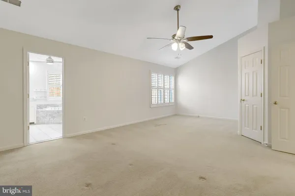 a bathroom with bathtub next to a window