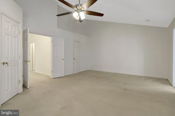 a white toilet sitting next to a shower