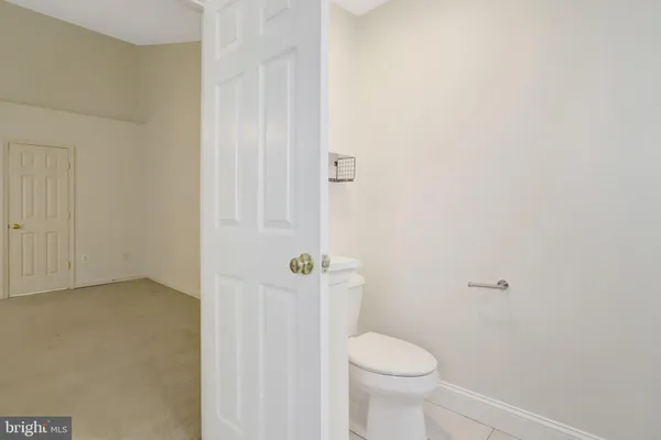a view of a backyard with brick wall and potted plants